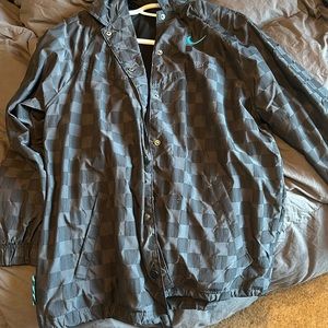 Nike black plaid with blue Nike jacket. Size medium in the men’s.